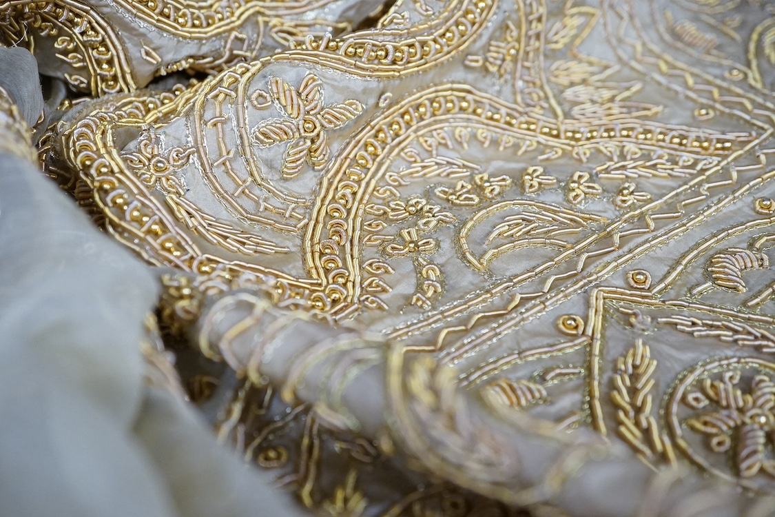 An Indian silk and metallic gold thread embroidered wall hanging, possibly for a wedding. Condition - fair/good